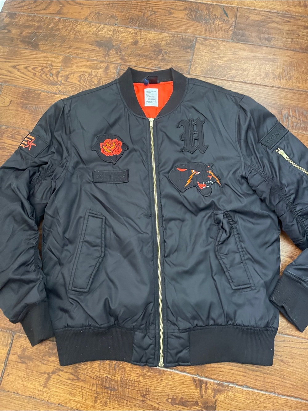 Divided Black Bomber Jacket with Red Lining and Embroidered Patches